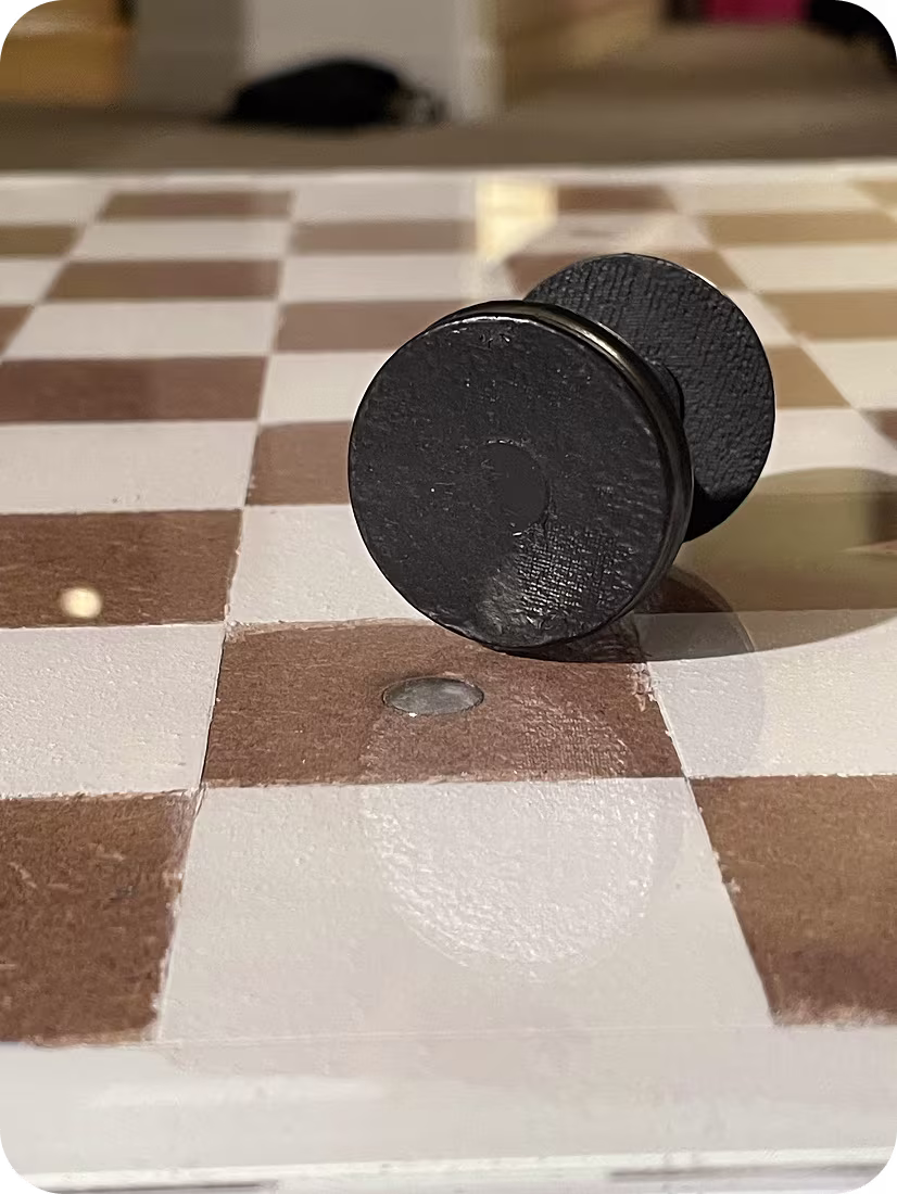 Close up of magnets in board and piece